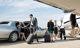 A group of people standing around an airport.